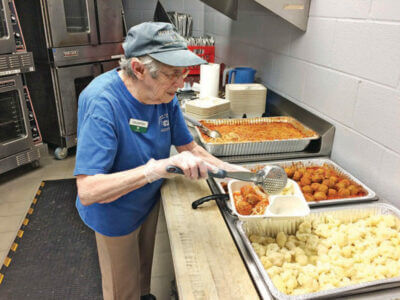 volunteer cooking food for seniors