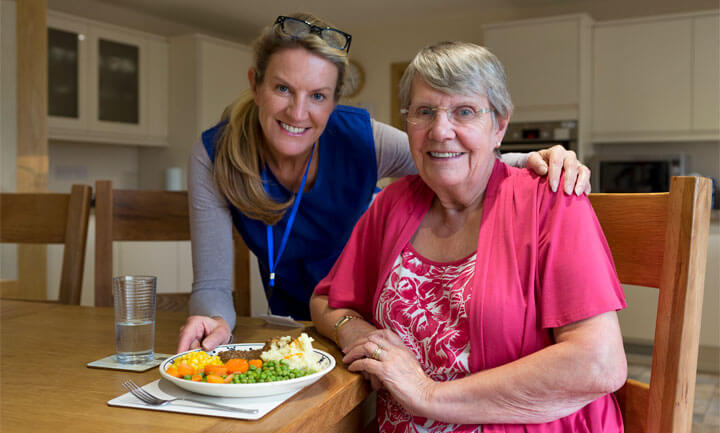 volunteer delivering meals to a senior