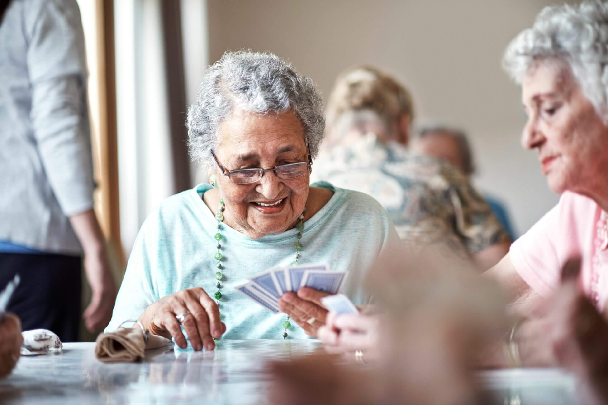 senior woman playing cards