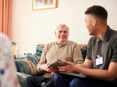 senior man with care worker at home