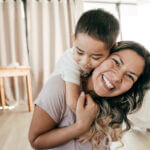 Mom laughing with her son.
