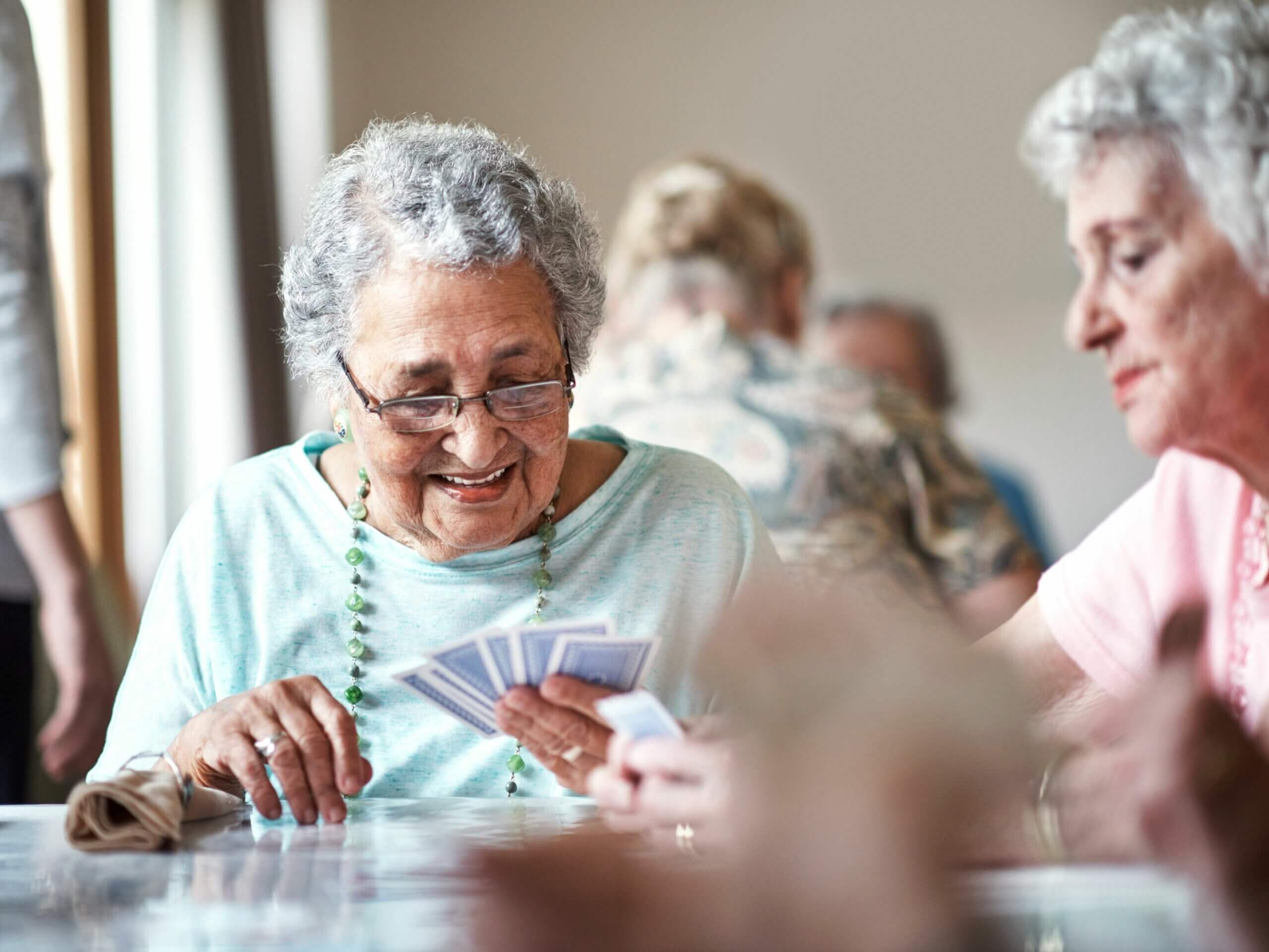 senior woman playing cards