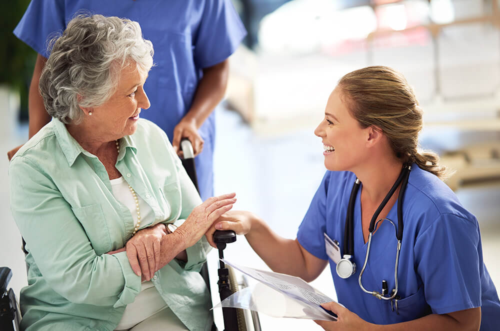 Shot of a doctor discussing treatments with a senior woman sitting in wheelchair in a hospital